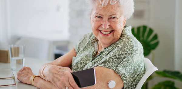 older woman, glucose monitor
