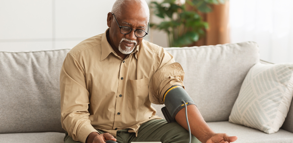 older male, senior , blood pressure monitor